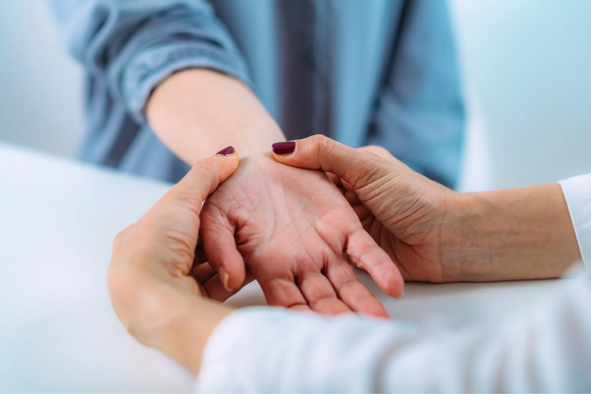 Doctor examining a senior patient with carpal tunnel syndrome.